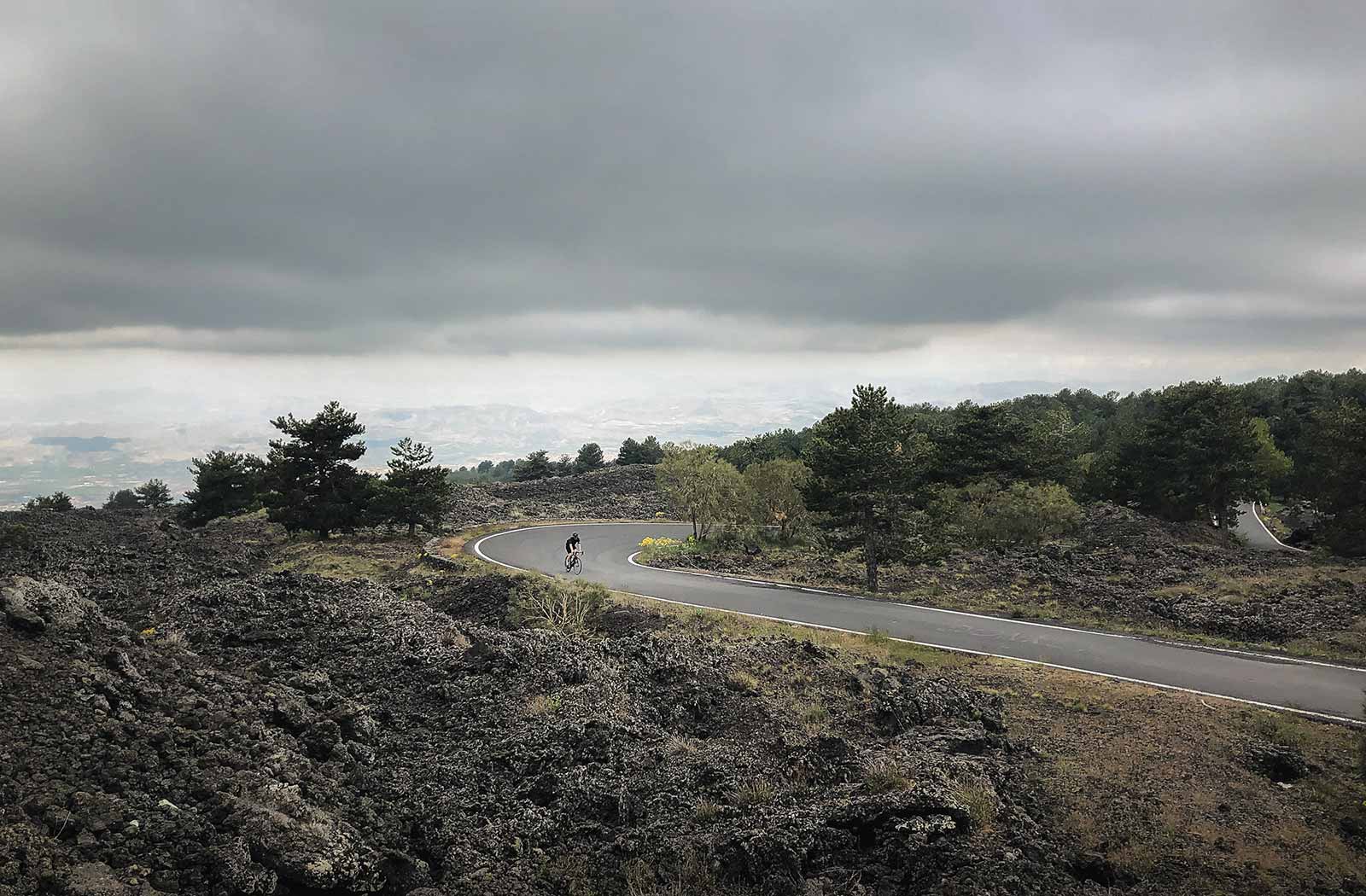 Sandro riding through the lava fields on Etna