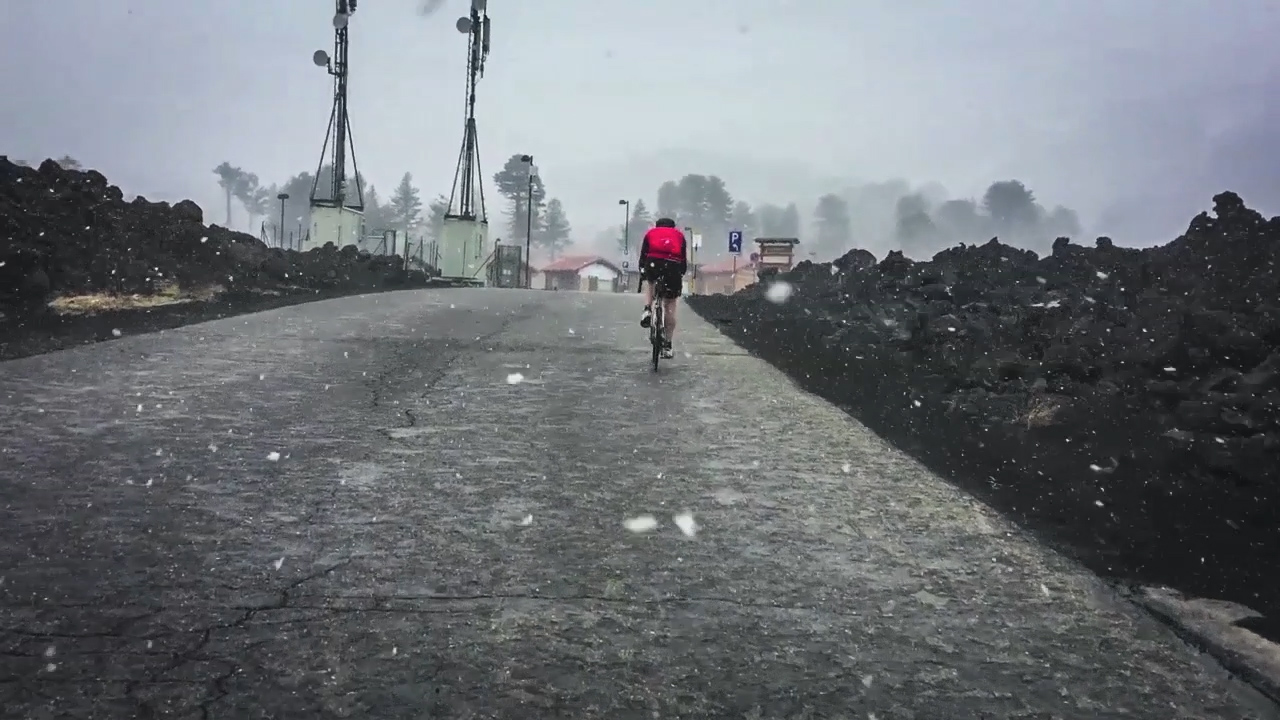 Cyclist on Etna in the snowstorm