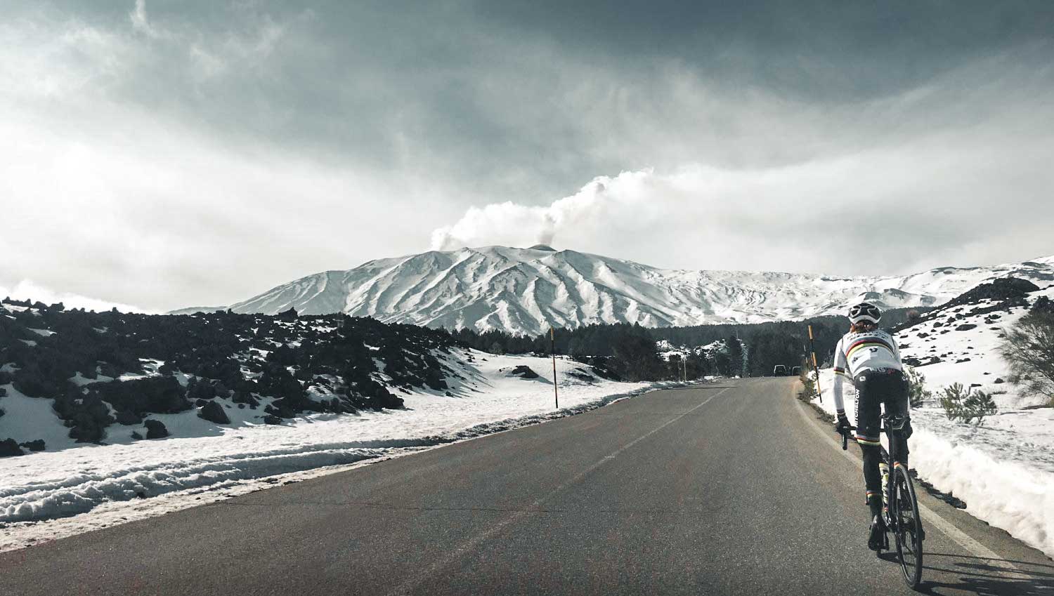 World Champion Annemiek van Vleuten riding up a snow covered Etna